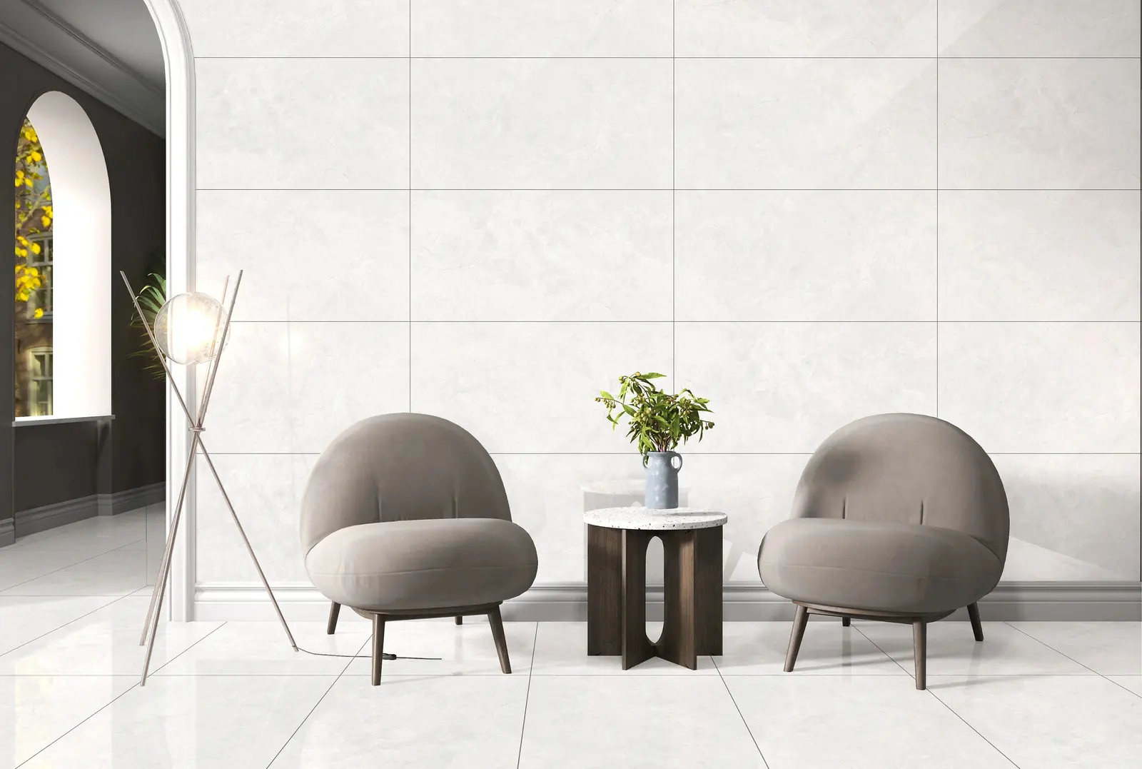 Reception with a soft grey stone-look wall and floor, two lounge chairs and an arched window